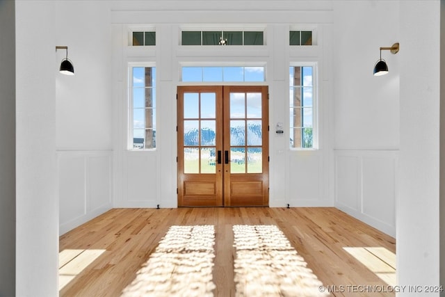 entrance foyer featuring light hardwood / wood-style flooring and french doors