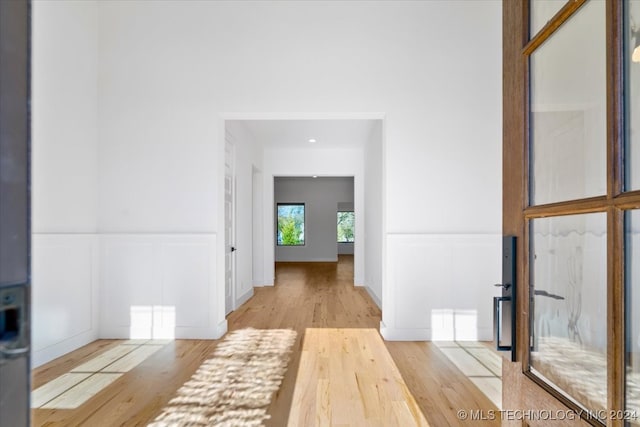 hallway with light hardwood / wood-style flooring