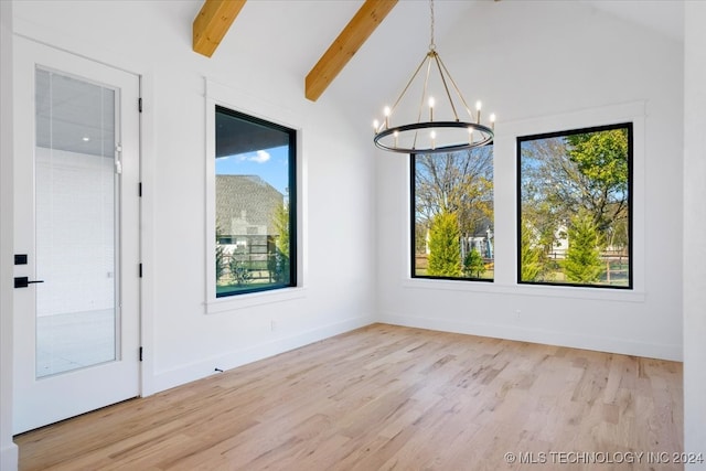 unfurnished dining area with plenty of natural light, lofted ceiling with beams, and light hardwood / wood-style flooring