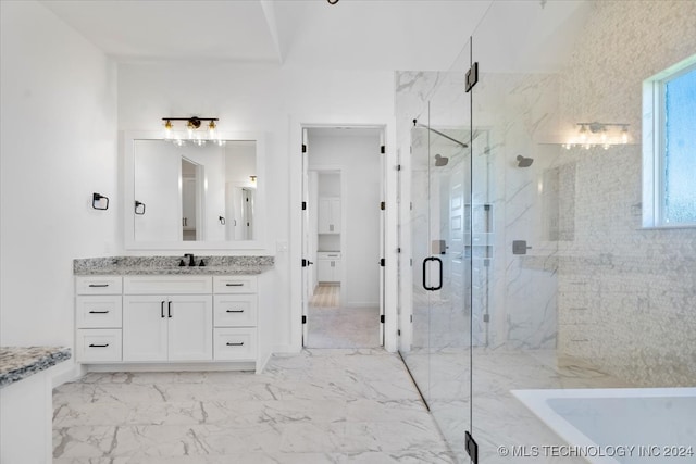 bathroom with vanity and separate shower and tub