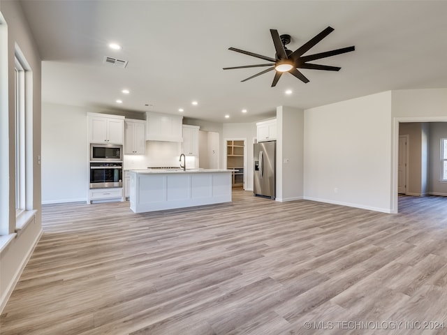 kitchen featuring a center island with sink, light hardwood / wood-style floors, white cabinetry, and stainless steel appliances