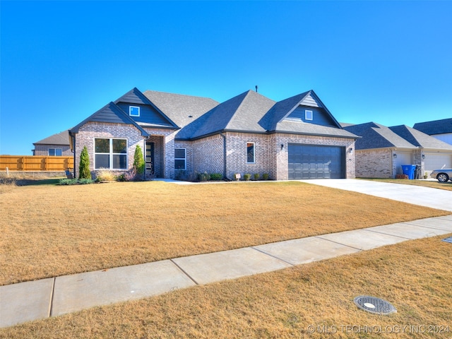 craftsman inspired home with a front yard and a garage