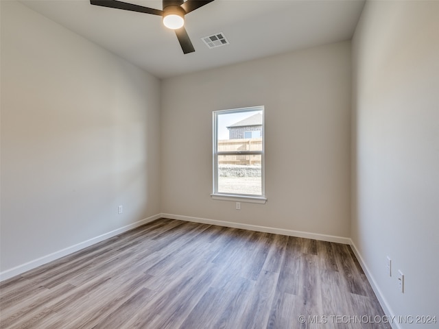 empty room with light wood-type flooring and ceiling fan