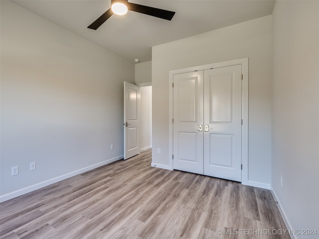 unfurnished bedroom with a closet, ceiling fan, and light hardwood / wood-style flooring