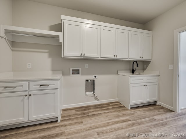 laundry area with electric dryer hookup, light hardwood / wood-style flooring, cabinets, and washer hookup