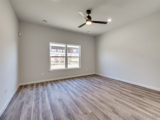 spare room with ceiling fan and light hardwood / wood-style flooring