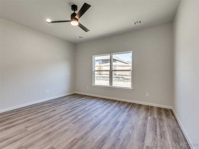 unfurnished room with ceiling fan and light hardwood / wood-style flooring