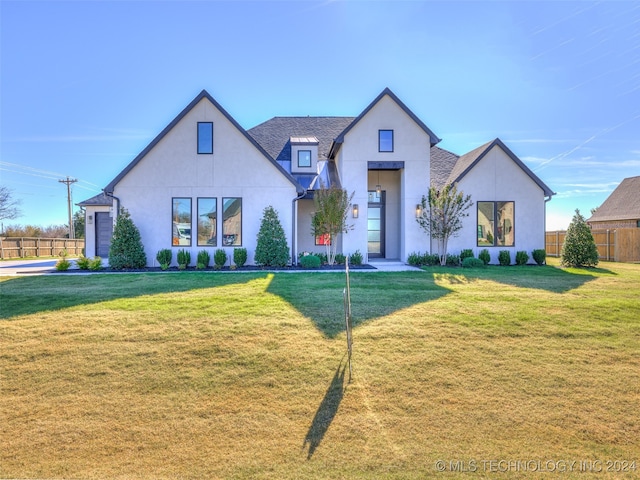 modern farmhouse style home featuring a front yard