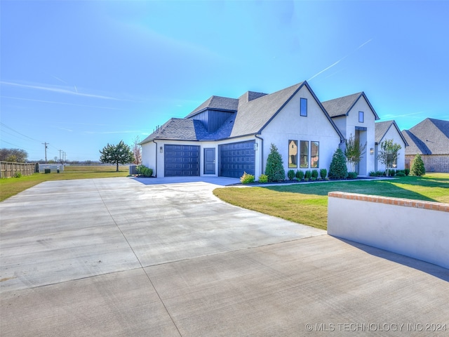 view of front of home with a front lawn and a garage