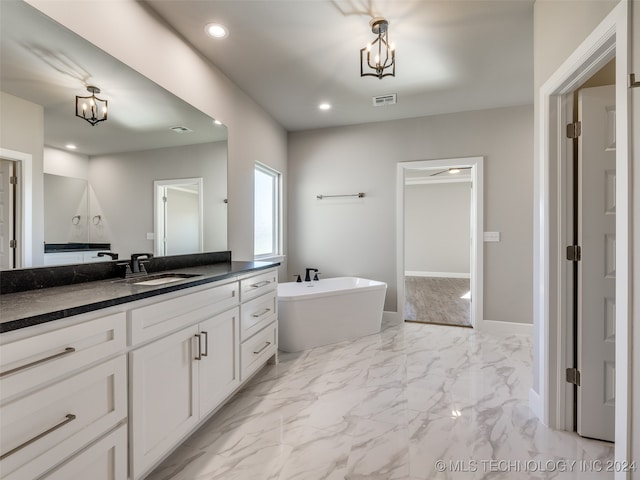 bathroom with a tub to relax in and vanity