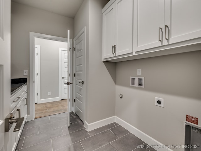 laundry area with cabinets, hookup for a washing machine, tile patterned flooring, and electric dryer hookup