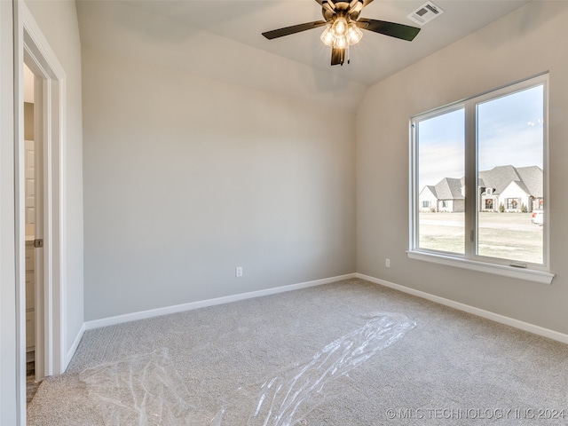 spare room with ceiling fan and light colored carpet