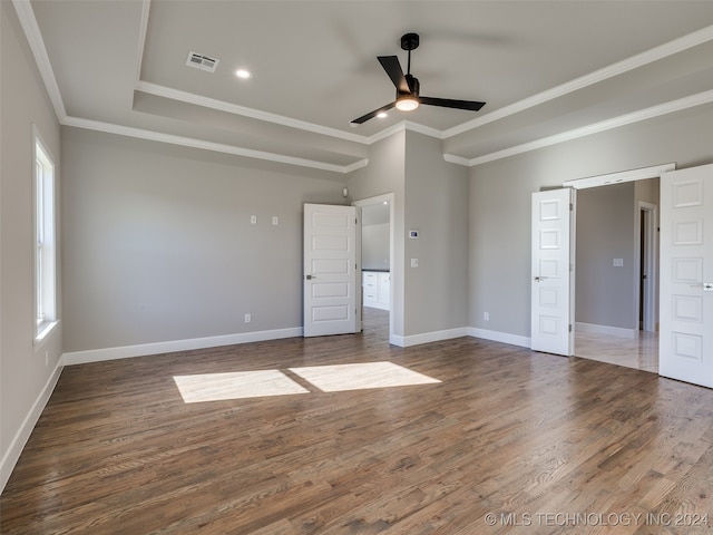 unfurnished bedroom with ceiling fan, dark hardwood / wood-style floors, and ornamental molding