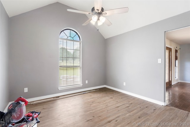 unfurnished room featuring lofted ceiling, wood-type flooring, and ceiling fan