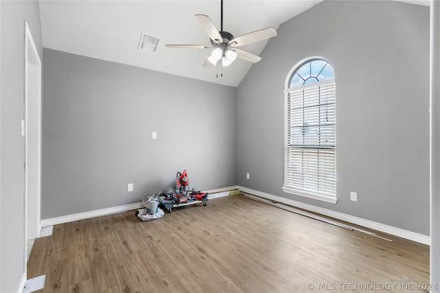 spare room with ceiling fan, hardwood / wood-style flooring, and lofted ceiling