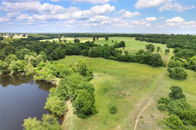 birds eye view of property featuring a water view and a rural view