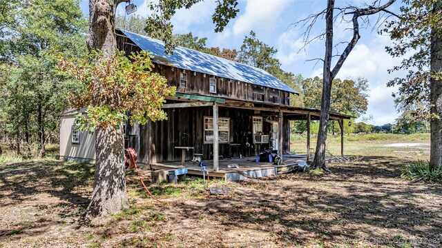 rear view of property featuring a deck