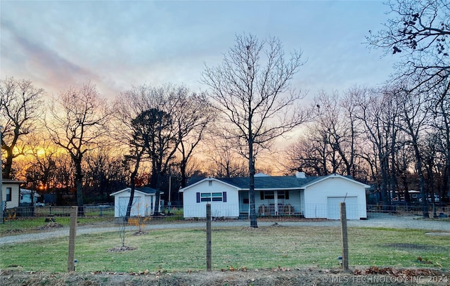 single story home with a yard and an outbuilding