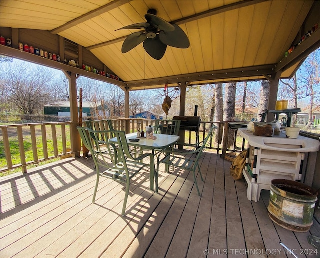 wooden deck featuring ceiling fan