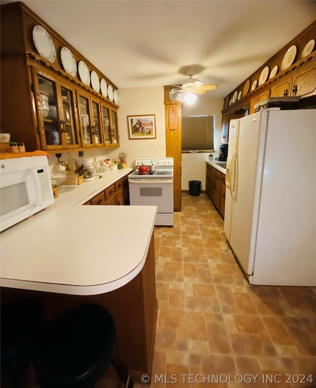 kitchen with kitchen peninsula, white appliances, and ceiling fan