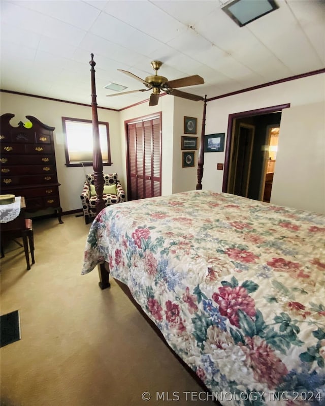 bedroom featuring a closet, ceiling fan, crown molding, and light carpet