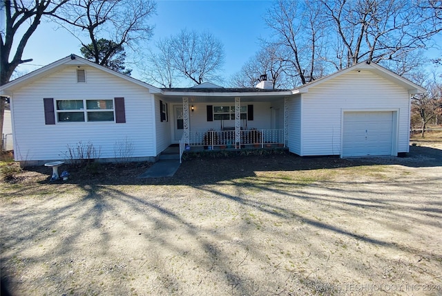 ranch-style house featuring a porch and a garage