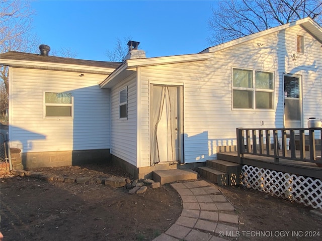 rear view of property featuring a deck