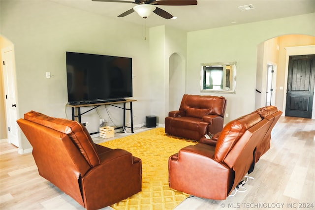 living room featuring ceiling fan and hardwood / wood-style floors