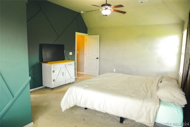 bedroom with carpet, ceiling fan, and lofted ceiling