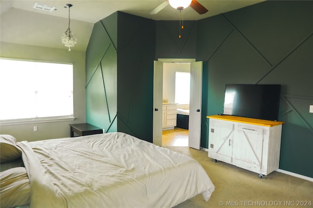 carpeted bedroom featuring ceiling fan, connected bathroom, and lofted ceiling