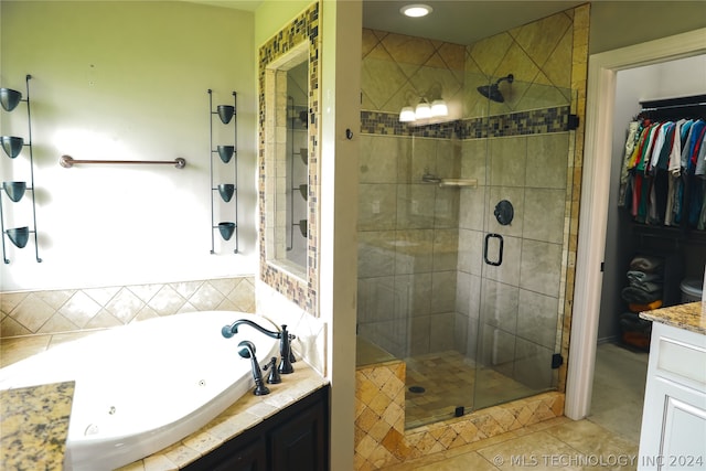 bathroom featuring tile floors, vanity, and plus walk in shower