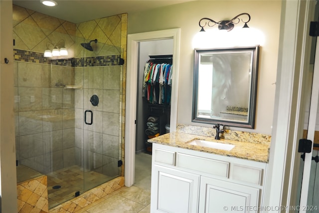 bathroom featuring tile flooring, an enclosed shower, and oversized vanity