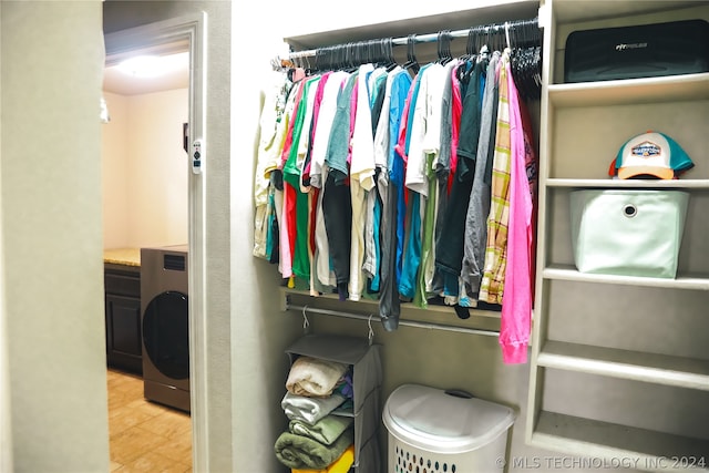 walk in closet with hardwood / wood-style flooring and washer / dryer