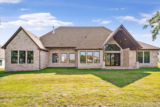 back of house featuring a yard and a patio