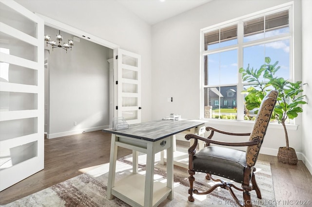 office with built in features, an inviting chandelier, and dark hardwood / wood-style flooring