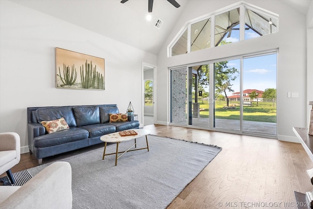 living room featuring high vaulted ceiling, wood-type flooring, and ceiling fan