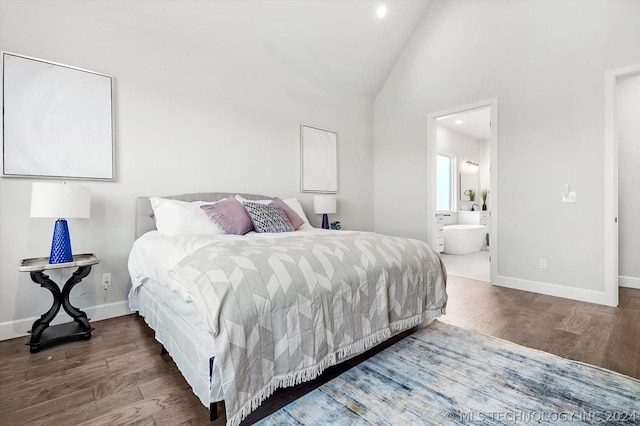 bedroom with dark wood-type flooring, connected bathroom, and high vaulted ceiling