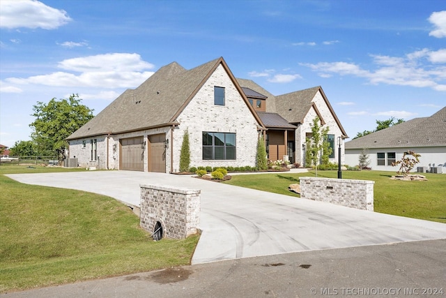 view of front of house featuring a garage and a front yard