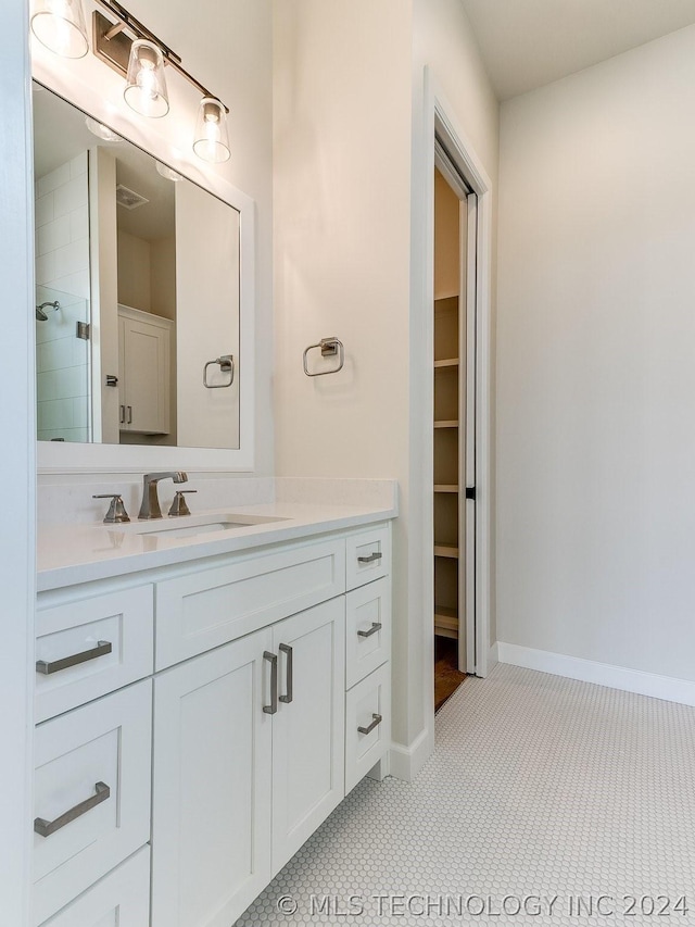 bathroom with vanity, tile patterned floors, and walk in shower