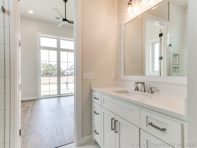 bathroom with ceiling fan, vanity, and wood-type flooring