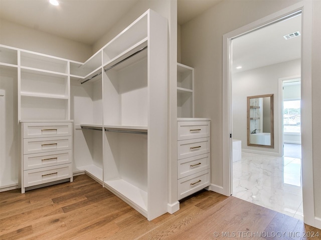 walk in closet featuring light hardwood / wood-style flooring