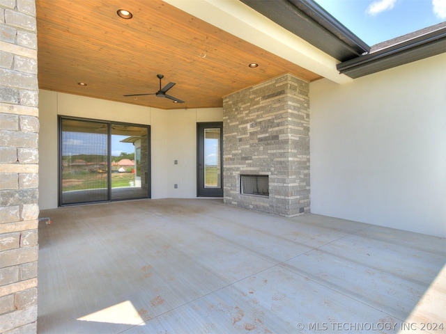 view of patio featuring ceiling fan and an outdoor stone fireplace