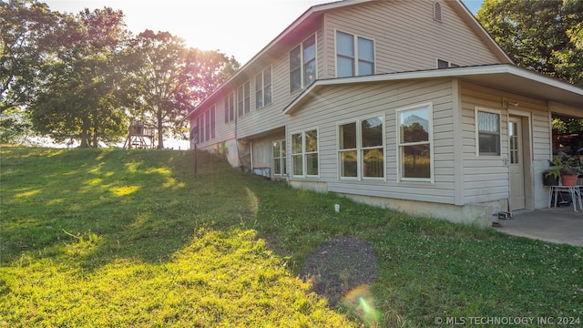 view of side of property with a lawn