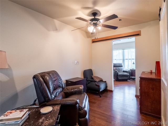 living area featuring dark hardwood / wood-style floors and ceiling fan