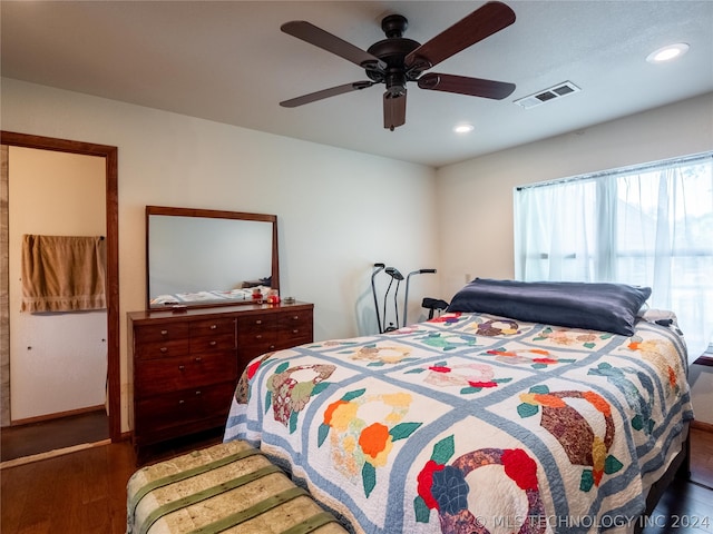 bedroom with ceiling fan and dark wood-type flooring