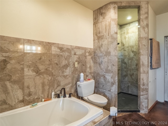 bathroom featuring shower with separate bathtub, tile walls, and toilet