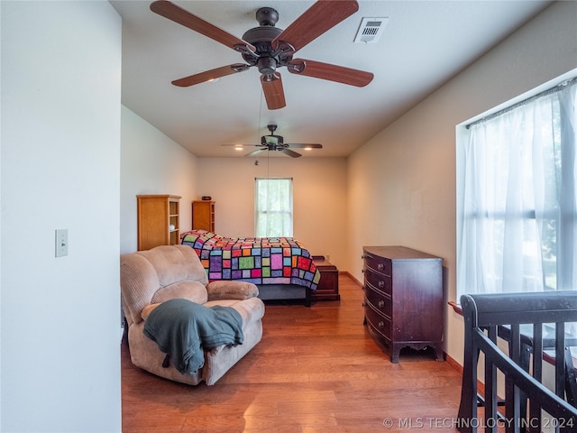 living room with ceiling fan and wood-type flooring