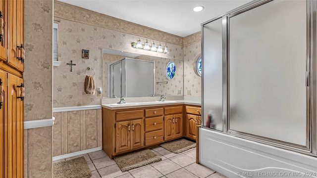 bathroom with vanity, tile patterned flooring, and enclosed tub / shower combo