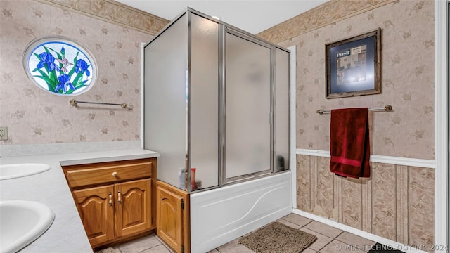 bathroom with enclosed tub / shower combo, vanity, and tile patterned floors