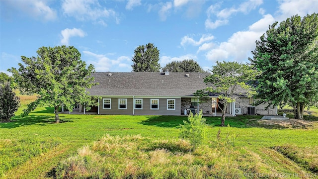 back of property featuring a patio area and a lawn